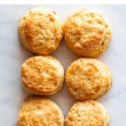 Six vegan biscuits on a marble surface.