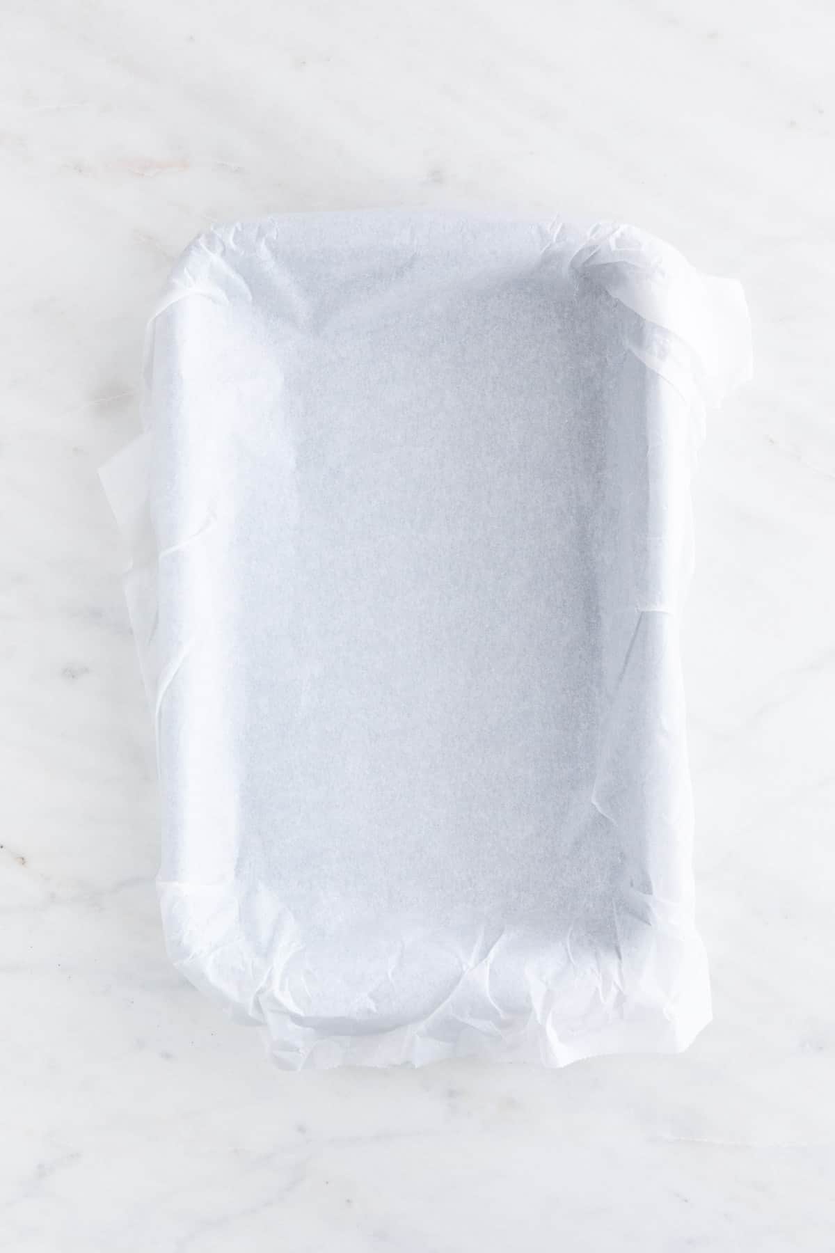A 7x11 inch pan lined with parchment paper.