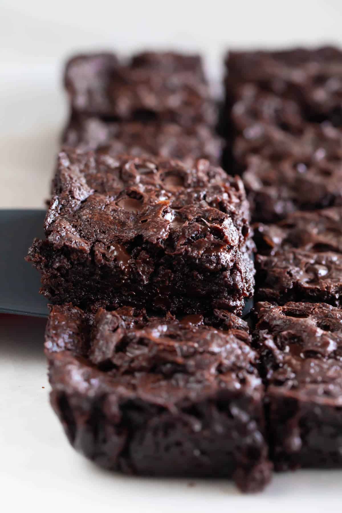 A spatula lifting a piece of brownie.