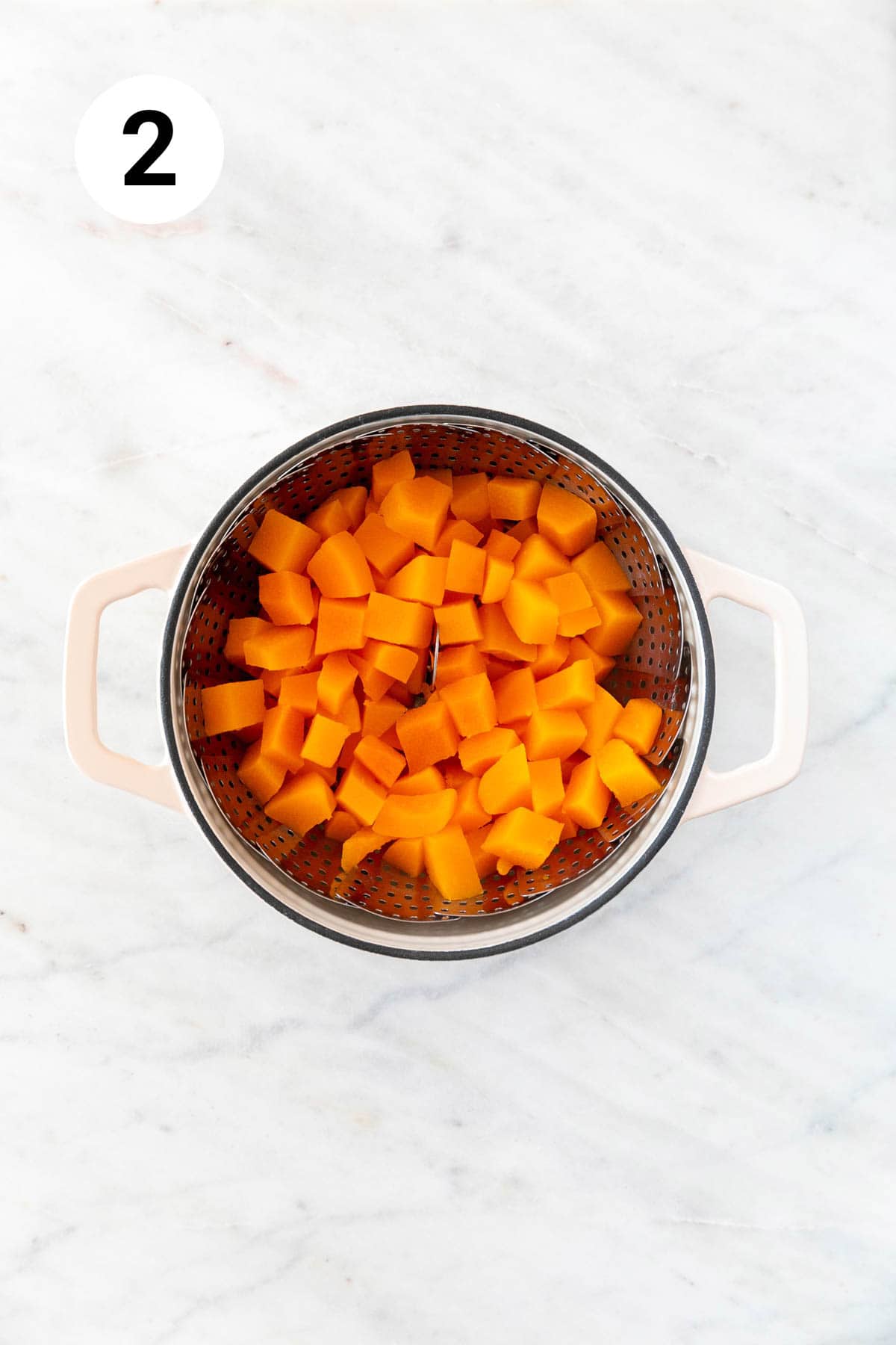 Steamed butternut squash in a pot.