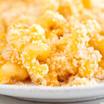 Vegan mac and cheese, baked in a white dish.