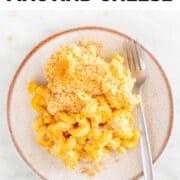 Baked vegan mac and cheese on a plate with a fork.