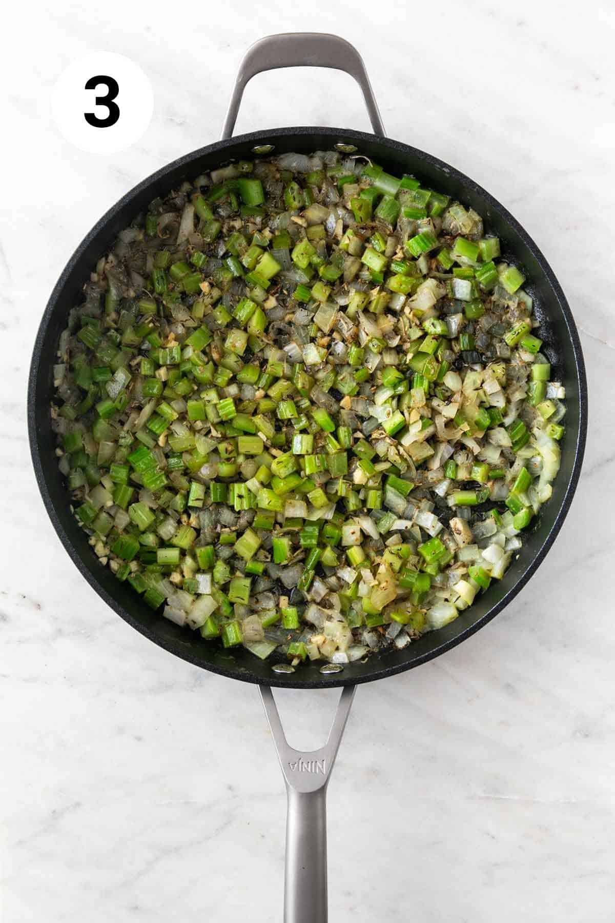 Sauteed veggies and spices in a skillet.