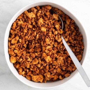 Crumbled tofu ground beef in a bowl with a spoon.