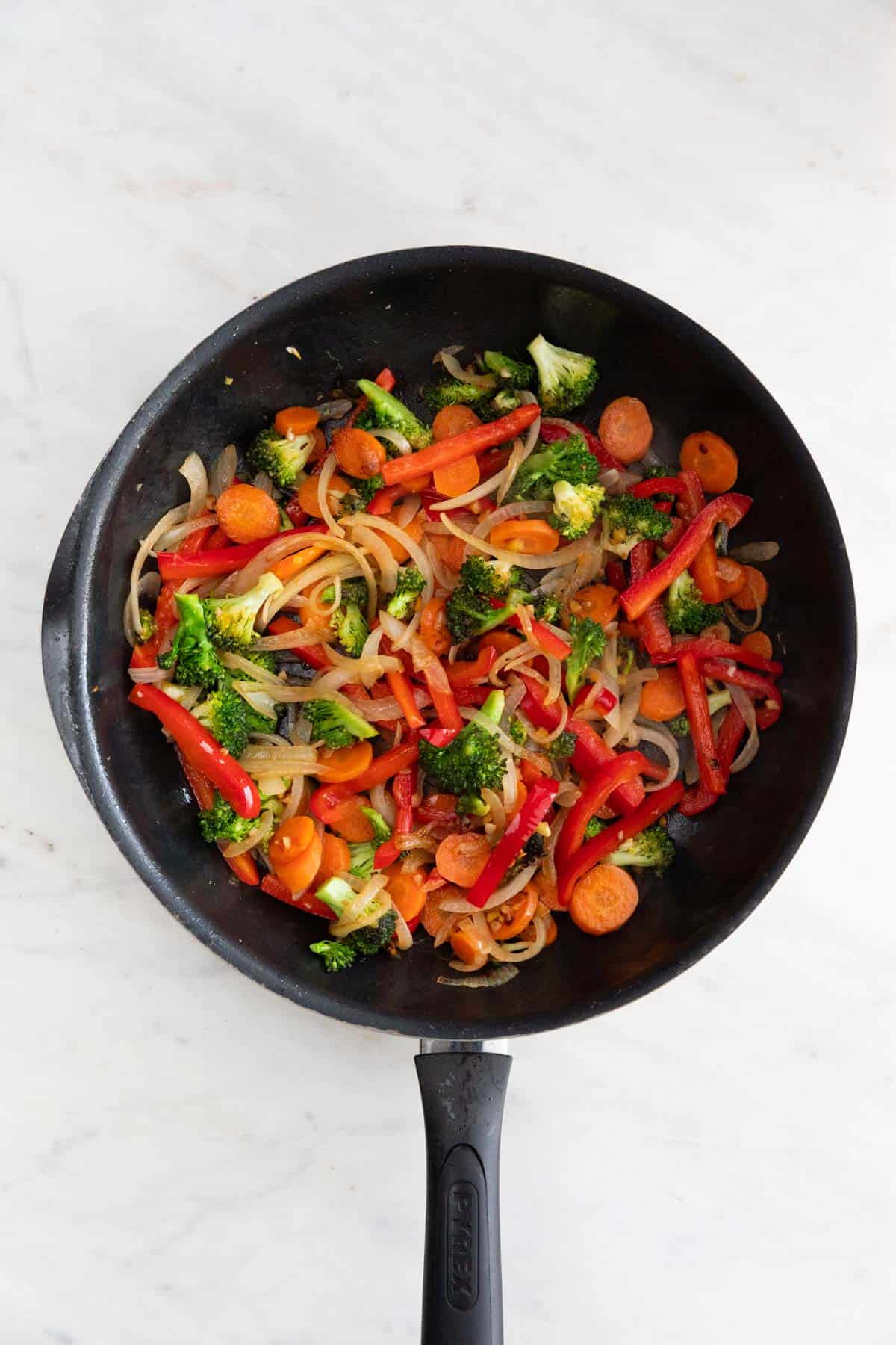 Sautéed veggies in a skillet.