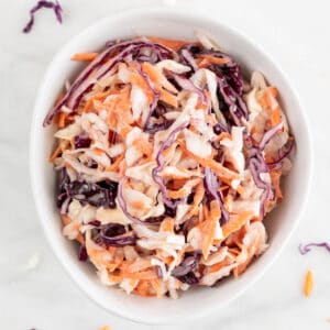 White bowl with vegan coleslaw.