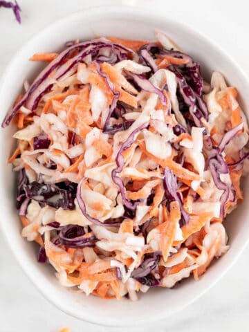 White bowl with vegan coleslaw.