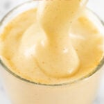 Close-up photo of a cup of turmeric latte with the words turmeric latte