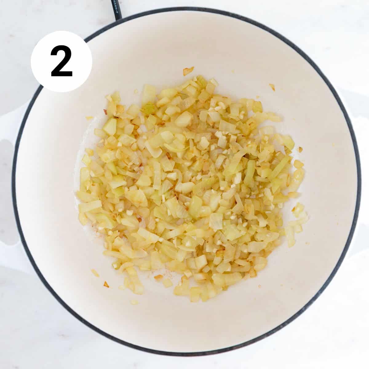 Sautéed onion and garlic in a pot.