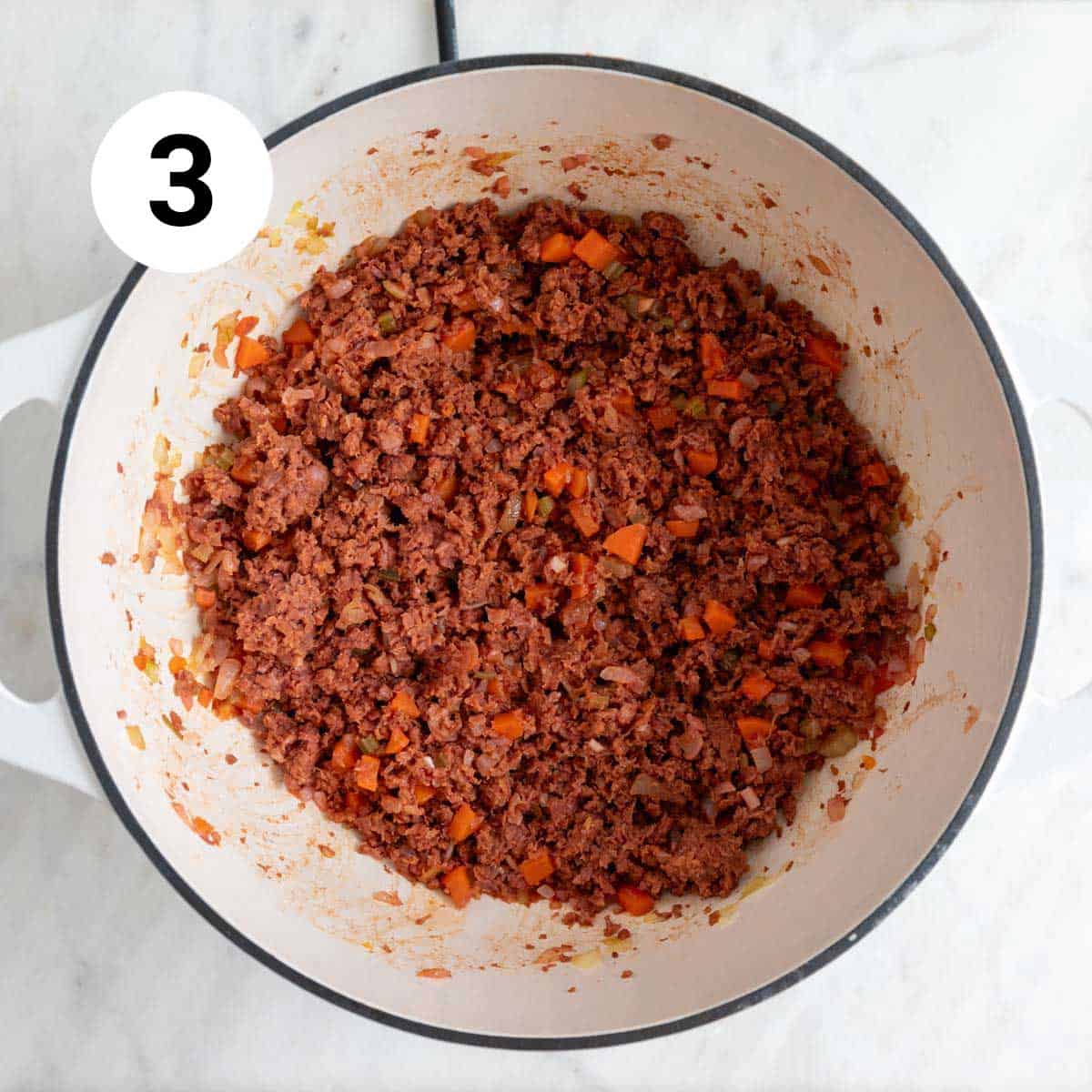 Sautéed veggies and vegan ground beef in a pot.