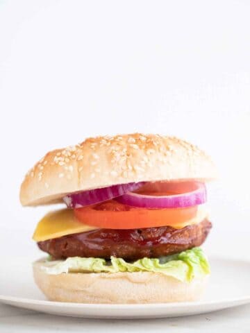 A side shot of a dish with a homemade vegan burger