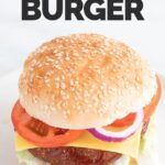 A picture of a vegan burger onto a white dish with the words vegan burger