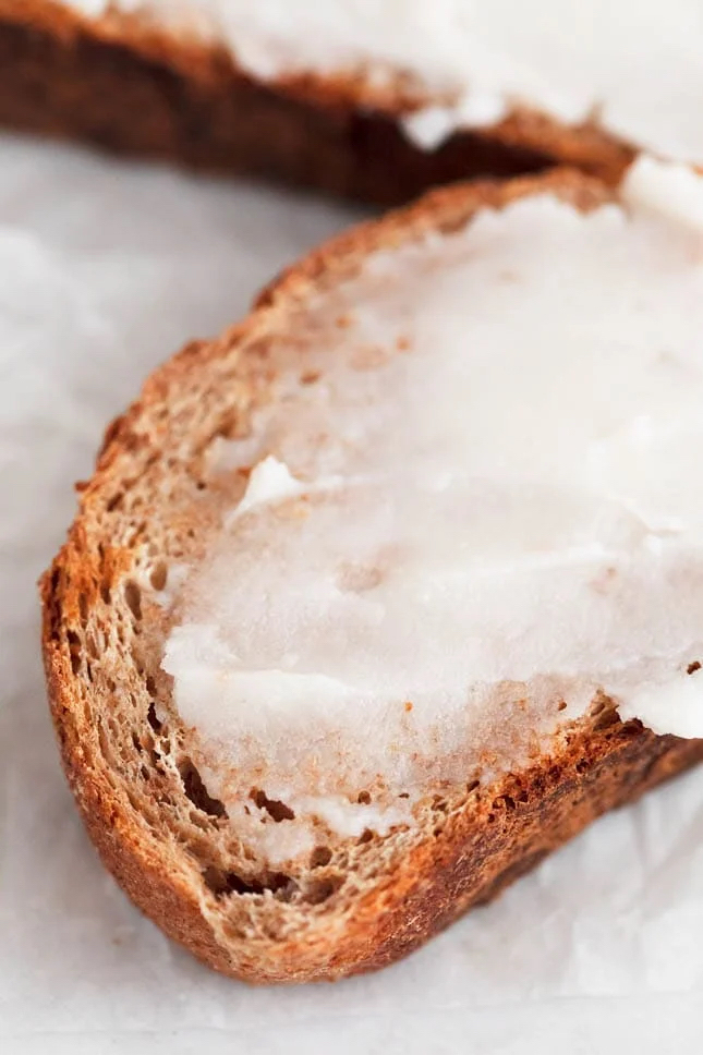 Photo of some vegan butter spread onto a slice of bread