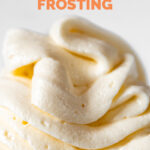 Close-up shot of a bowl of vegan buttercream frosting with the words vegan buttercream frosting