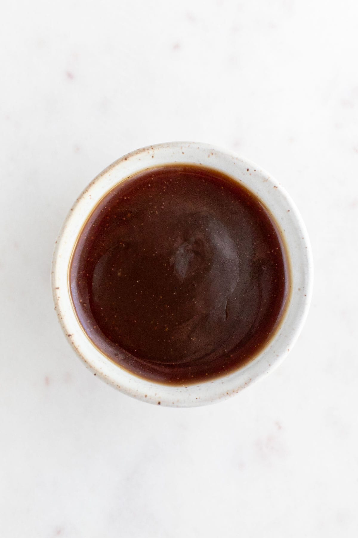 Small bowl with vegan caramel sauce.
