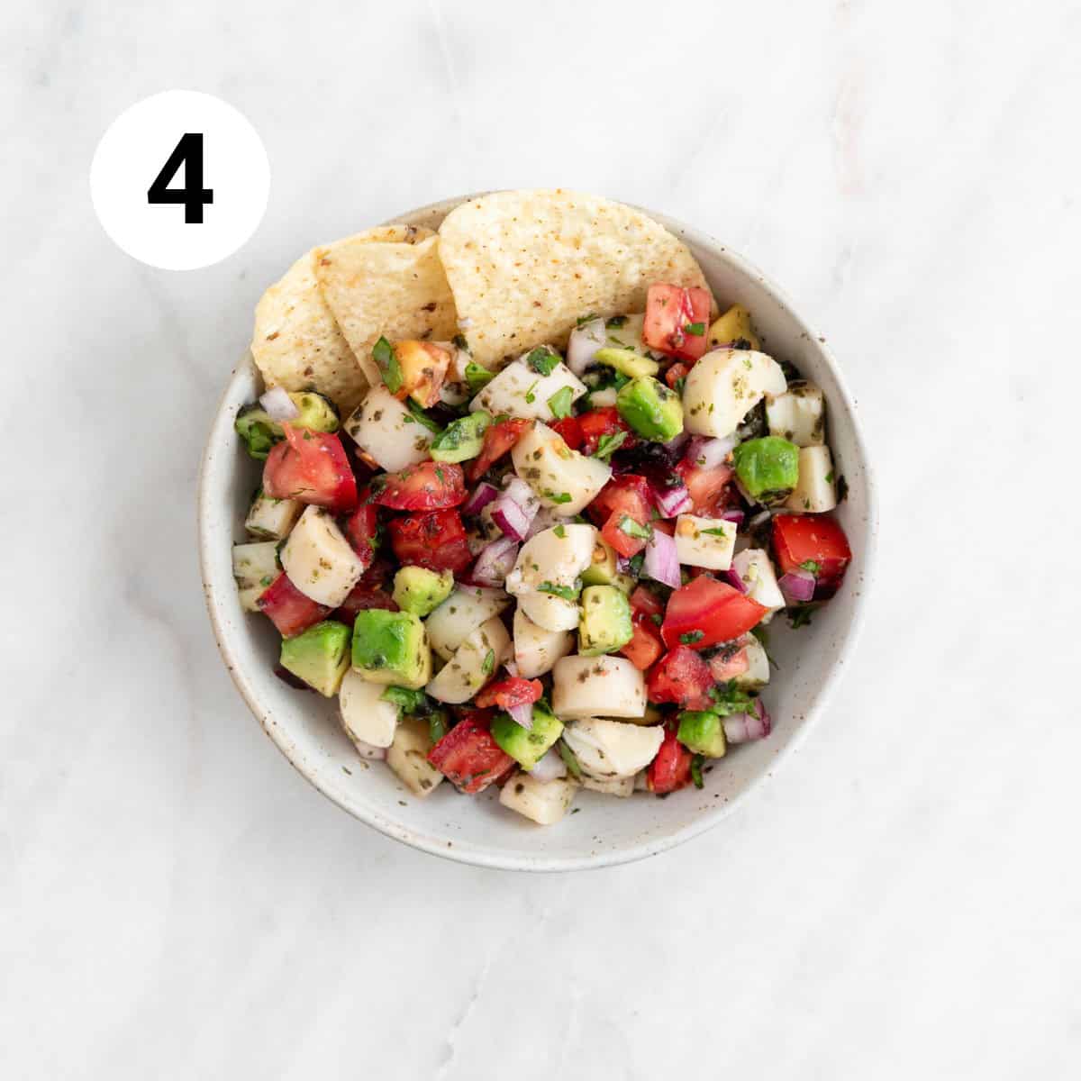 Vegan ceviche served in a small bowl with tortilla chips.