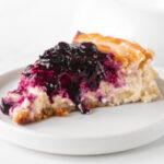 Square photo of a slice of vegan cheesecake