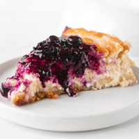 Square photo of a slice of vegan cheesecake