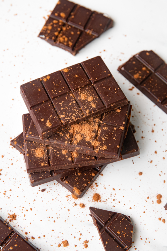 Photo of 2 barks of vegan chocolate with some cocoa on top