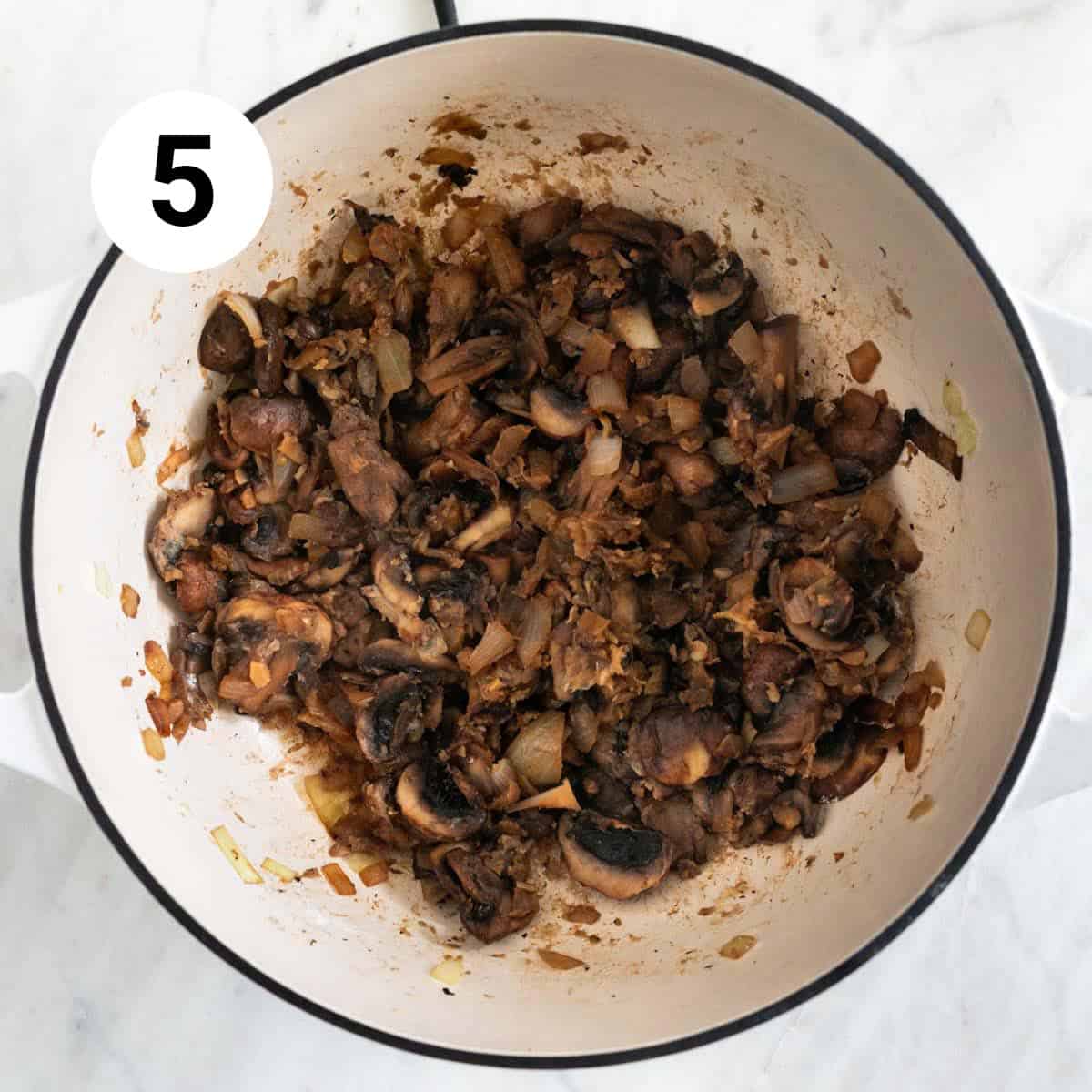 Mushrooms, garlic, onion, wine, and flour cooked in a large pot.