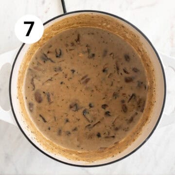 Vegan cream of mushroom soup with coconut milk in a pot before blending.