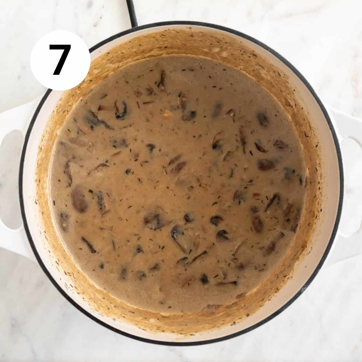 Vegan cream of mushroom soup with coconut milk in a pot before blending.