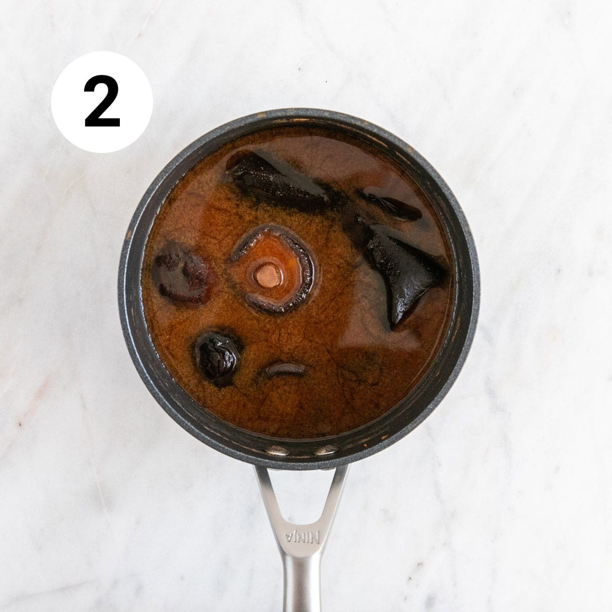 Cooked vegan fish sauce in a saucepan before draining.