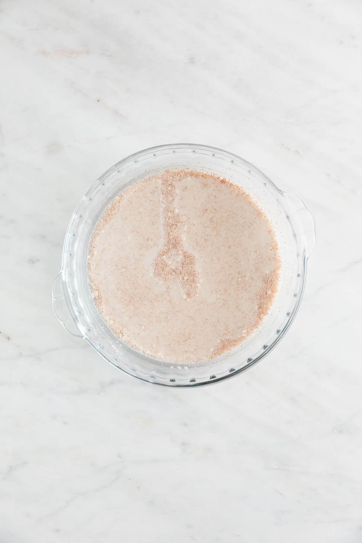 The batter to make vegan French toast in a shallow dish.