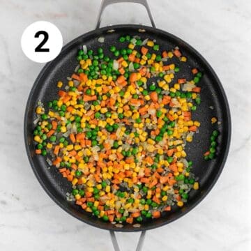Sautéed veggies in a large pan.