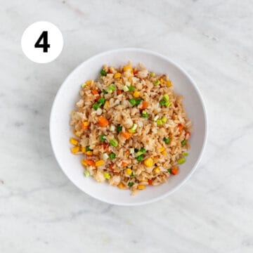 Platter featuring vegan fried rice atop a white plate.