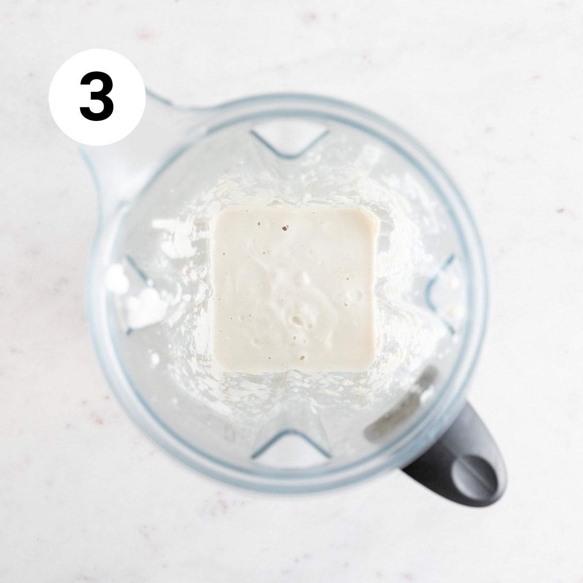 Vegan heavy cream substitute in a blender jar.