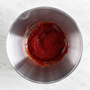 Kimchi paste in a bowl with gochugaru added.