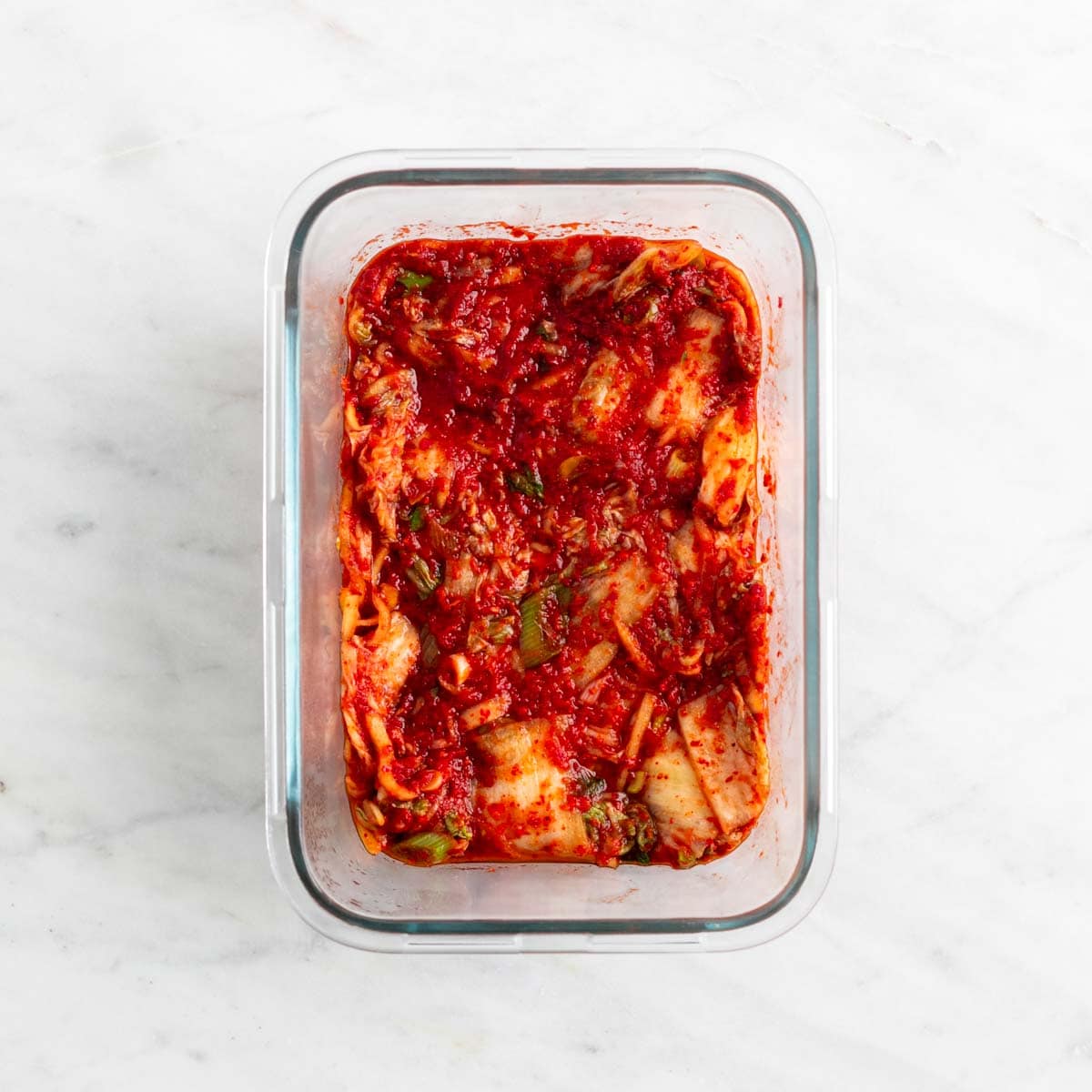 Vegan kimchi in a glass container after fermenting.