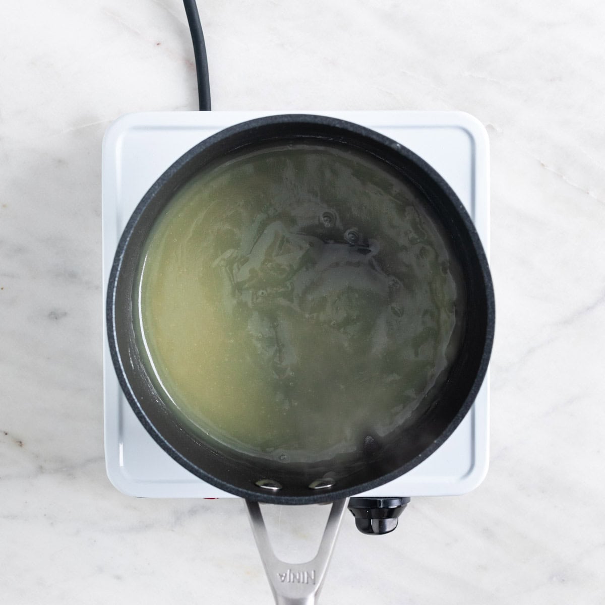 Rice porridge in a saucepan on the stove.