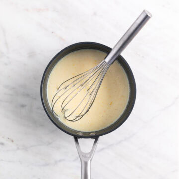 Ingredients for vegan lemon curd mixed in a saucepan, except for food coloring and vegan butter.