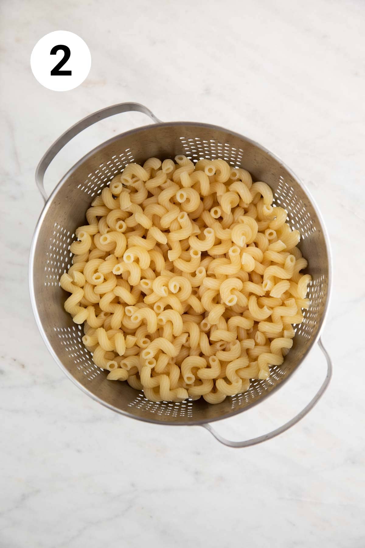 Draining cooked pasta in a strainer.