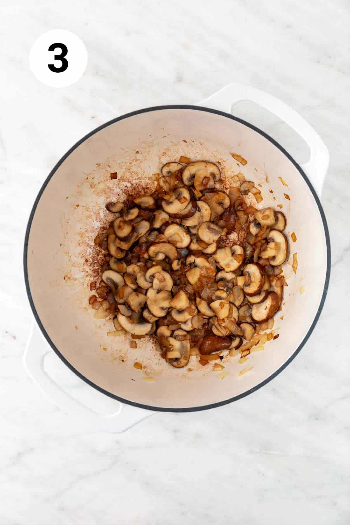 Sautéed onion, garlic, and mushrooms in a large pot.