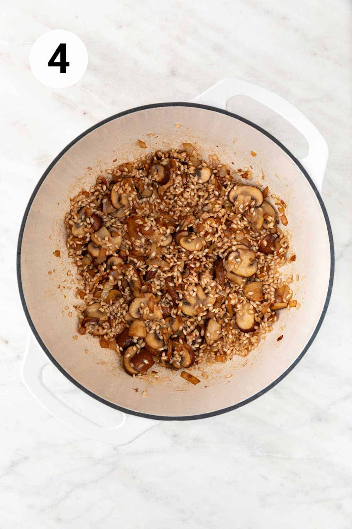 Sautéed onion, garlic, mushrooms, and Arborio rice in a large pot.