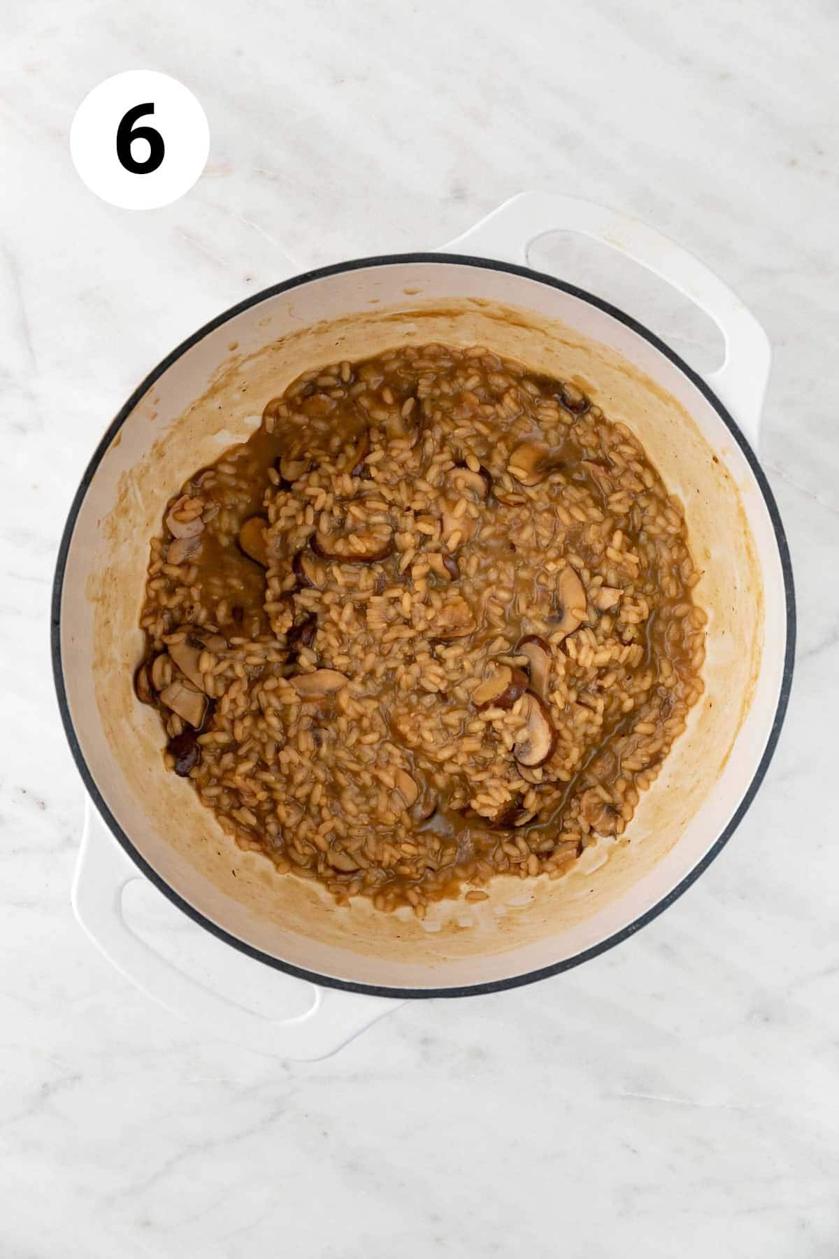 Cooked vegan mushroom risotto in a large pot before adding vegan butter, vegan parmesan, salt, and pepper.