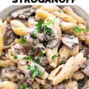 Bowl of vegan mushroom stroganoff garnished with parsley and pepper.