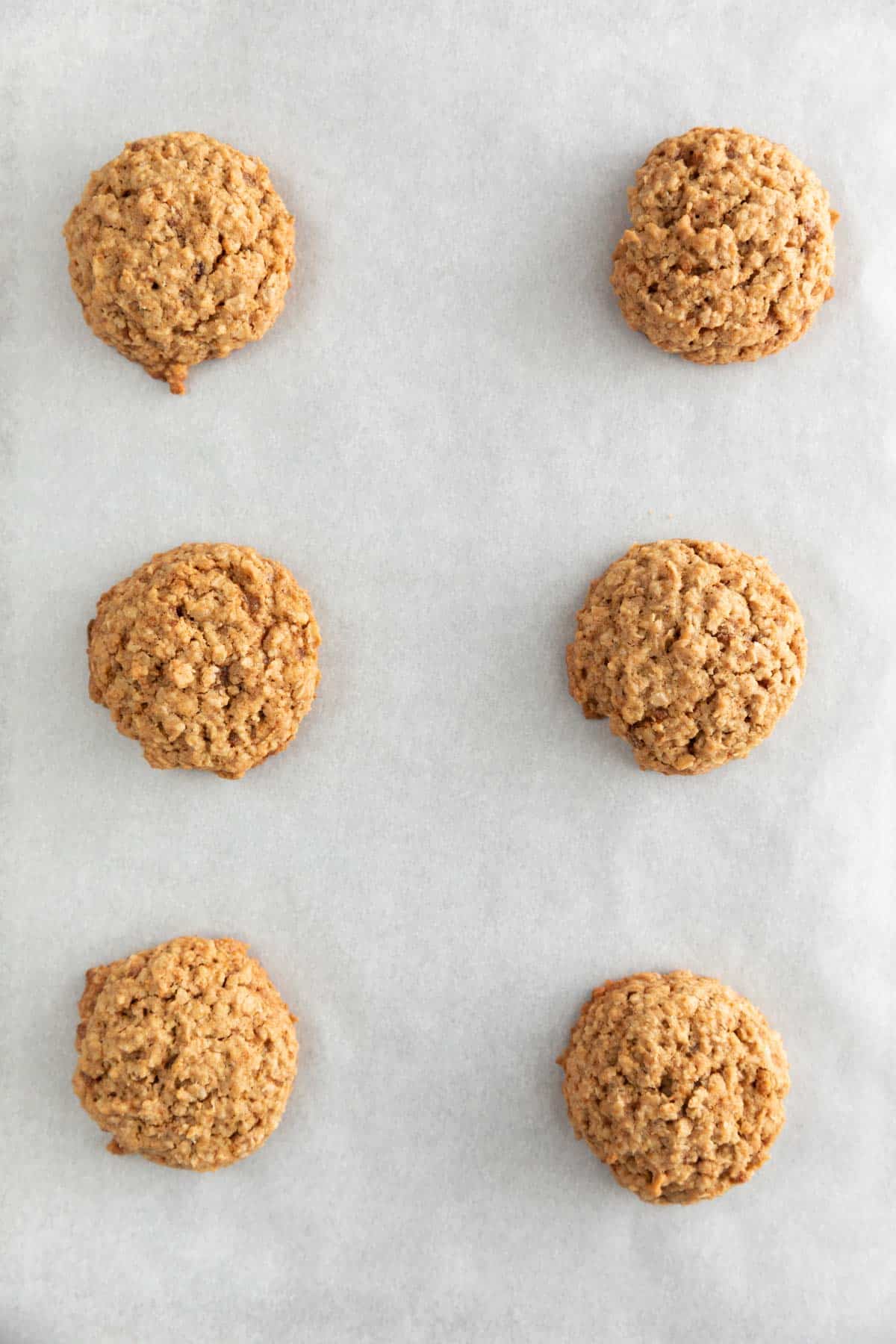 Baked vegan oatmeal cookies onto a lined baking sheet.