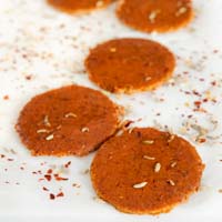 Square photo of some slices of vegan pepperoni
