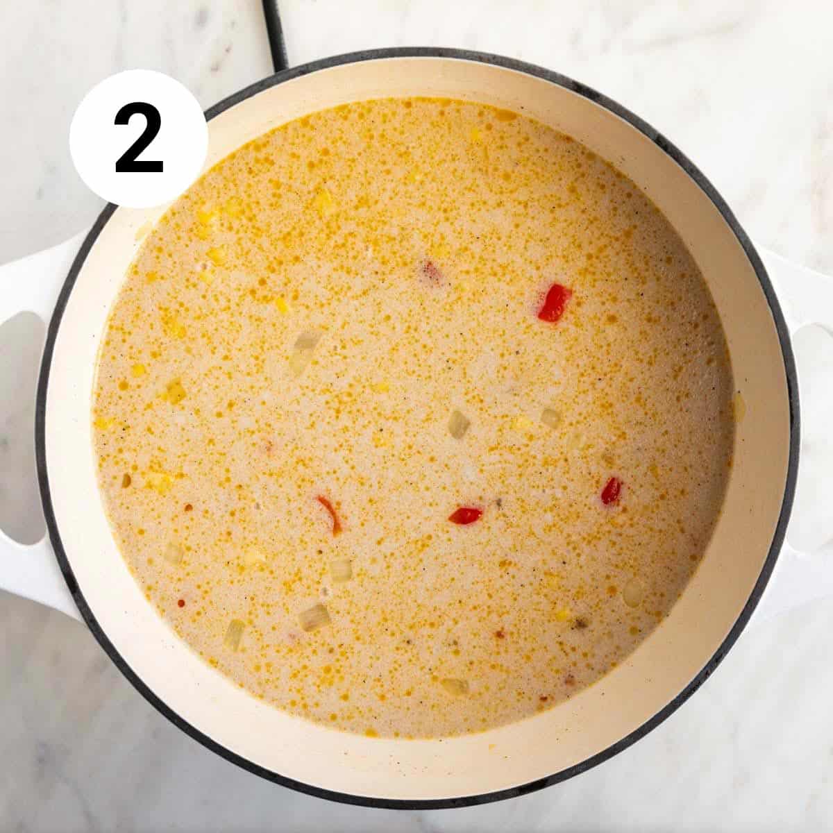 Vegan potato and corn chowder ingredients in a large pot before cooking.