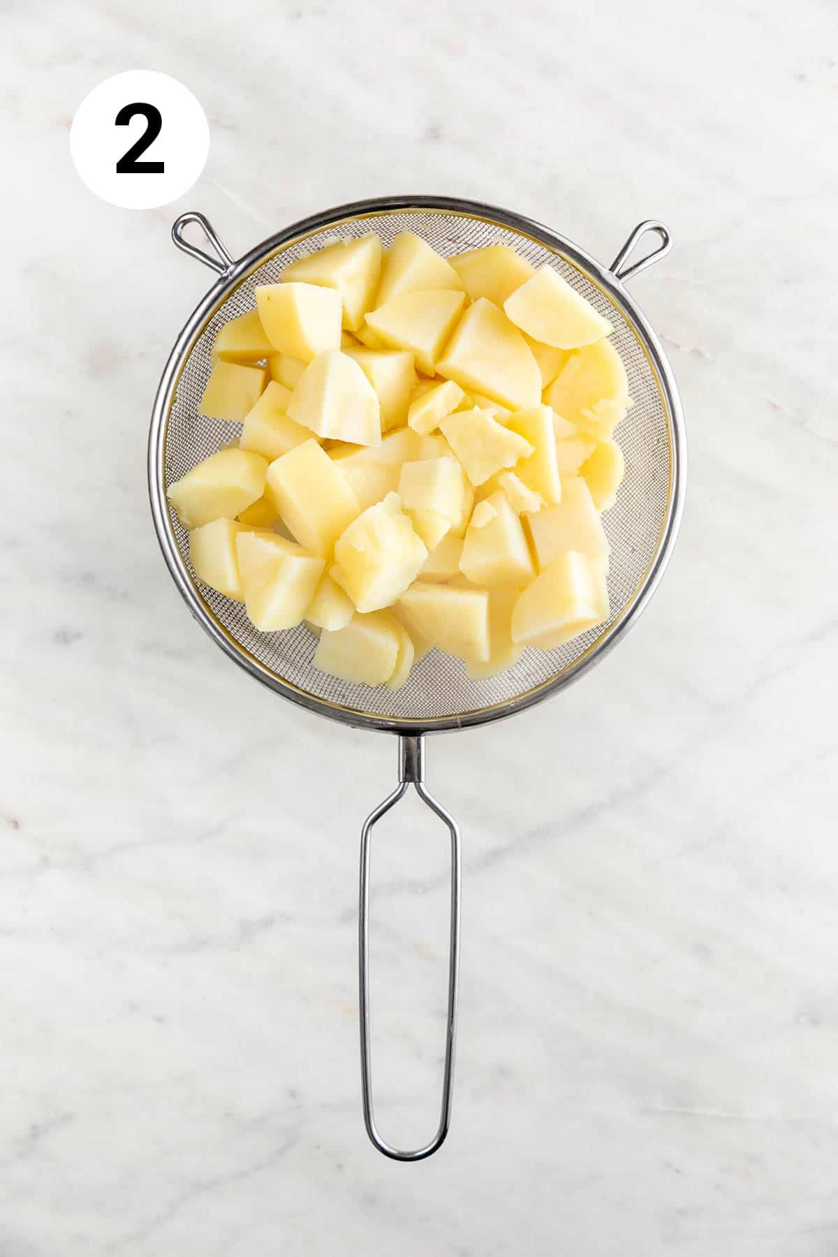 Boiled potatoes in a colander.
