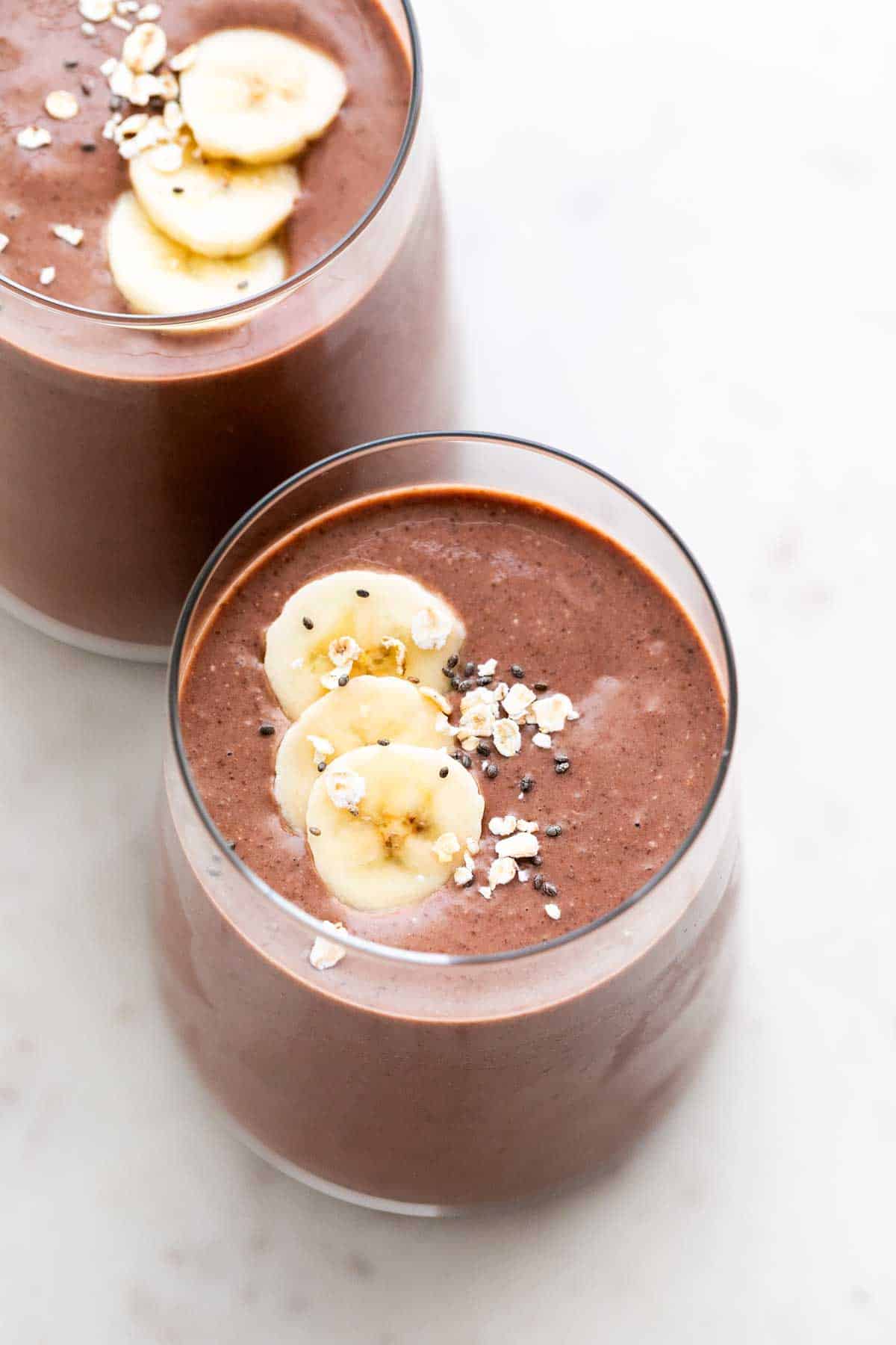 Two glasses brimming with vegan protein shake.