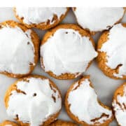 Vegan pumpkin cookies topped with vegan cream cheese frosting.