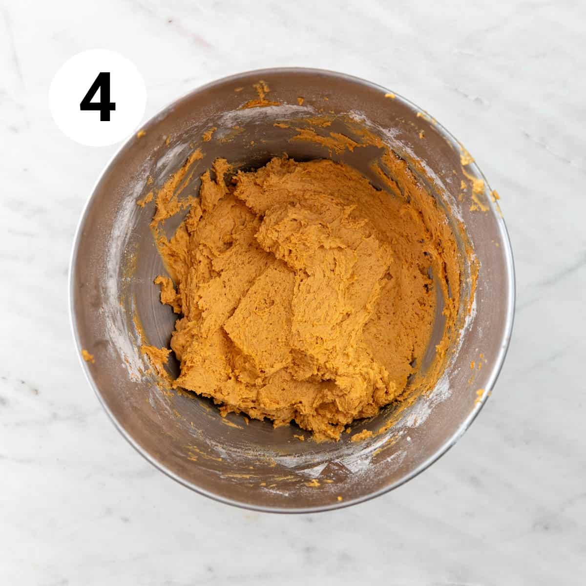Vegan pumpkin cookie dough in a stand mixer bowl.