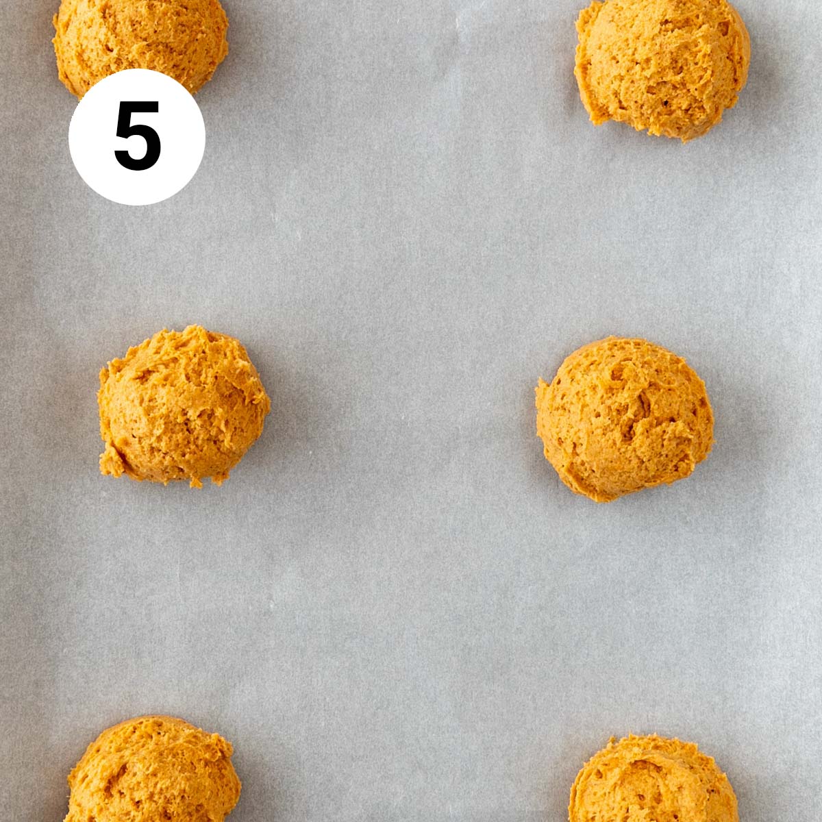 Vegan pumpkin cookies onto a lined baking sheet before baking.