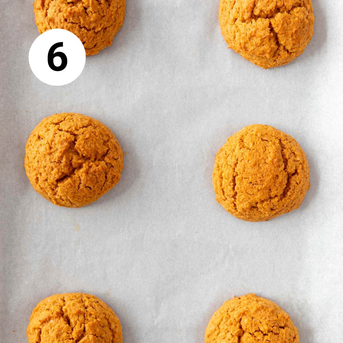 Baked vegan pumpkin cookies onto a lined baking sheet.