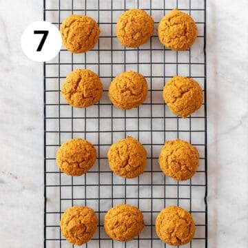 Baked vegan pumpkin cookies onto a cooling rack.